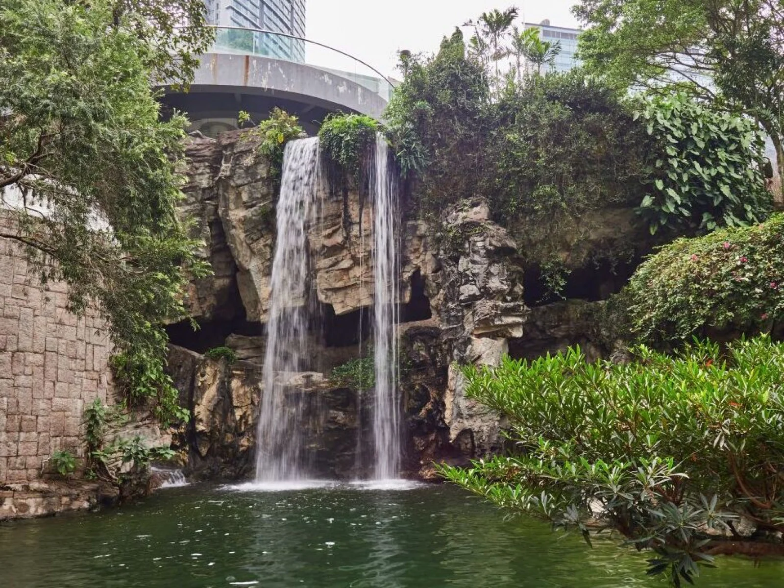 Cascada rodeada de árboles en Hong Kong Park